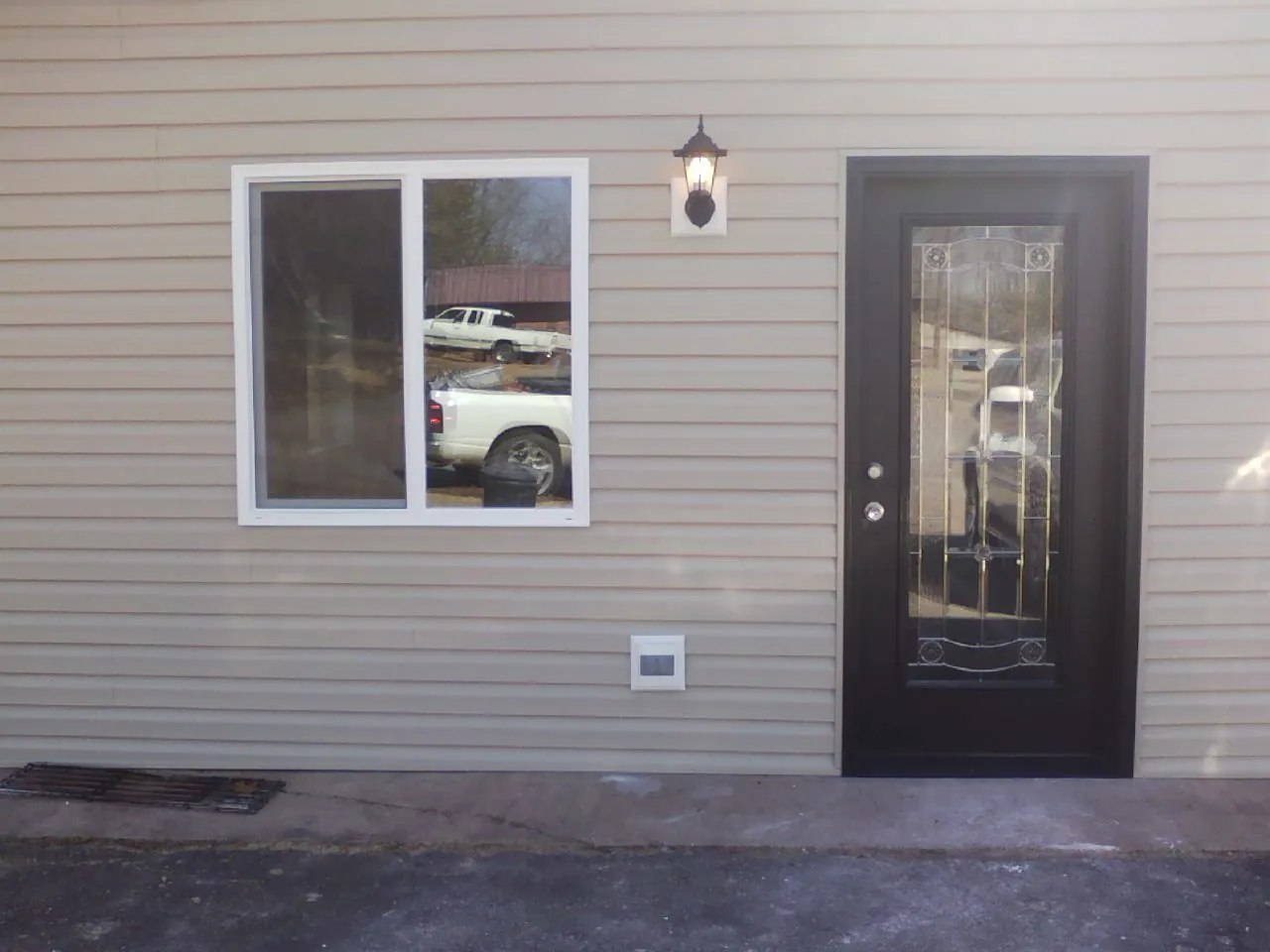New siding, window and entry door on the side of an addition in Wheelwright